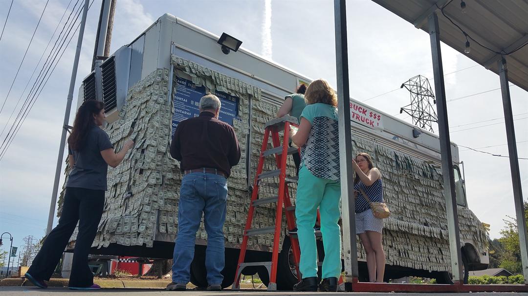 Customers cover taco truck with money to help owners